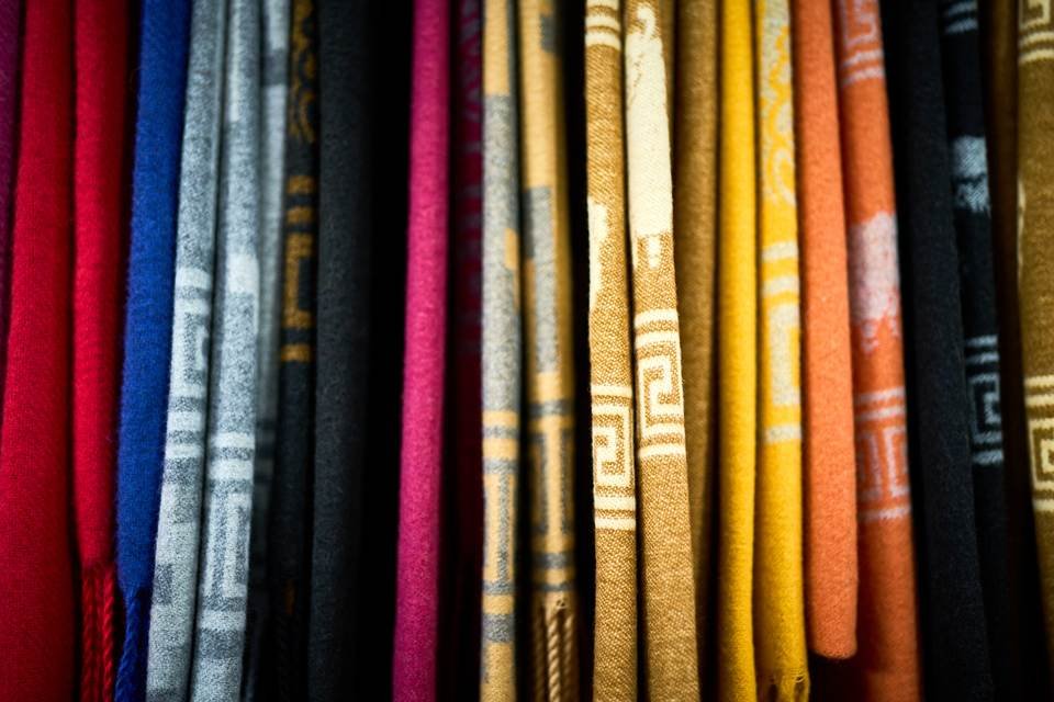 Hilera de textiles de distintos colores en la tienda